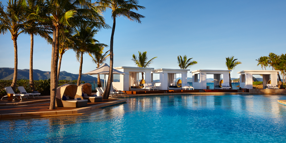 Pool with cabanas and palm trees