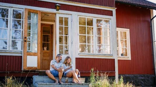 Couple sitting on cottage steps.