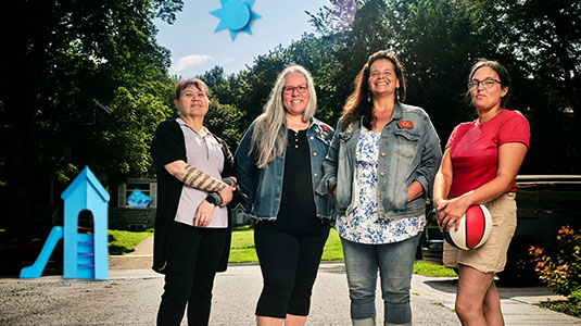 Four women standing in backyard