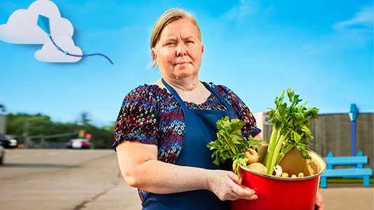 Woman standing holding vegetables