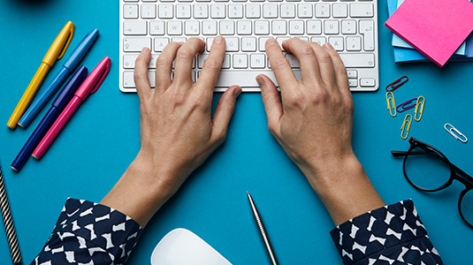 Woman typing on keyboard