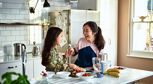 Mother and daughter cooking in kitchen