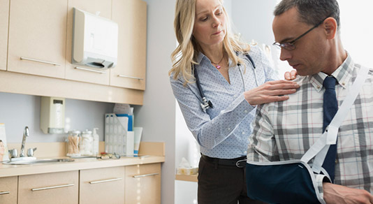 Doctor checking patient's arm sling