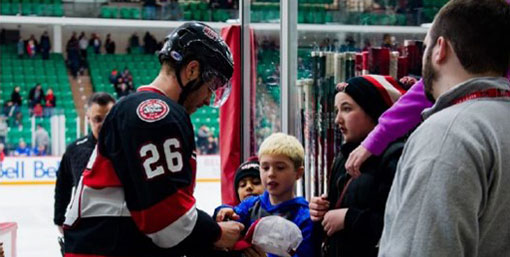 Hockey player signing autograph