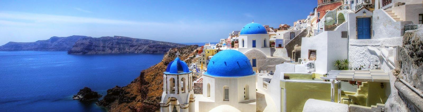 Santorini, Oia, view to caldera and Greek Orthodox Church at sunset