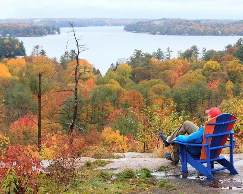 Man sitting on Muskoka chair