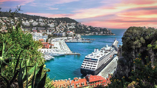 Cruise ship leaving port, with tropical foliage