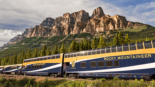 Mountains with Rocky Mountaineer train driving by